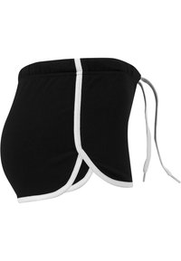 Short de sport noir avec bordure blanche et fente latérale, équipé d'une taille élastique et d'un cordon blanc à l'arrière.
