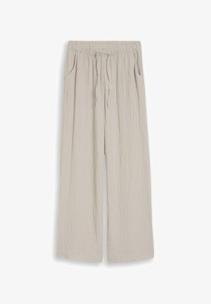 Light beige wide-leg pants with an elastic waistband, adjustable drawstring, side pockets, and a textured fabric finish.