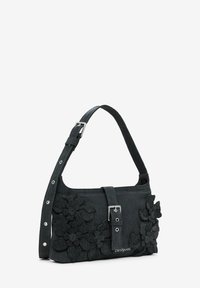 Black fabric shoulder bag with floral appliqué details, silver hardware buckle, and adjustable strap. Smooth texture, compact rectangular shape.