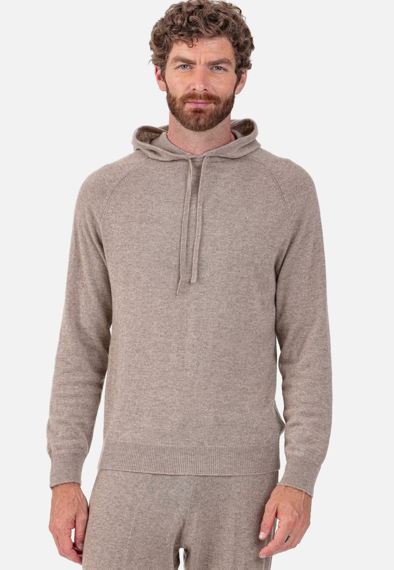 Sweat à capuche en maille texturée de couleur brun clair avec cordon de serrage, manches longues et poignets et ourlet côtelés. Coupe décontractée avec une apparence douce.