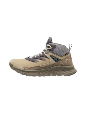 High-top hiking shoe in beige and gray with thick sole, mesh upper, lace-up front, and heel pull tab, designed for outdoor use.