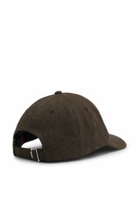 Brown herringbone cap with a curved brim and adjustable fabric strap at the back. Features stitching and ventilation holes.