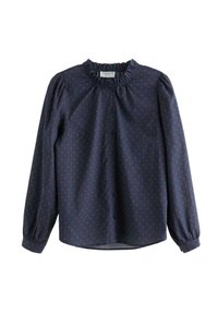 Tmavě modrá halenka s dlouhými rukávy, volánovým límcem a malým potiskem červených srdíček. Má zapínání na knoflíky a nařasené manžety pro lepší přizpůsobení.