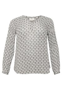 Chemisier à manches longues avec un motif en éventail noir et blanc répétitif et un col rond.