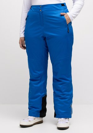 Pantalons de ski bleus fabriqués en matériau lisse et résistant à l'eau. Comprend un panneau d'accent noir et des poches zippées. Coupe légèrement ample.