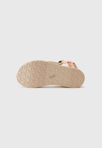 Sandal with a textured beige rubber sole featuring a geometric pattern, colorful woven straps in pink and orange, and an adjustable black buckle.