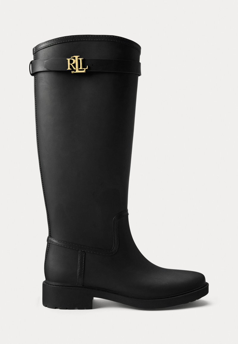 Black rubber knee-high boot with a flat sole, glossy finish, and a gold logo accent near the top. Features a smooth texture and streamlined design.