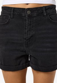 Black denim shorts with a high-waisted design, rolled cuffs, front pockets, and a metal button closure. Smooth texture and classic fit.