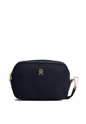 Petit sac bandoulière noir rectangulaire compact avec fermeture éclair dorée, logo TH doré à l'avant et bandoulière noire amovible avec boucle dorée.
