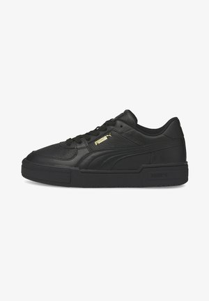 Black leather sneakers with a textured finish, featuring a thick sole and gold Puma branding on the side. Lace-up design and padded collar.