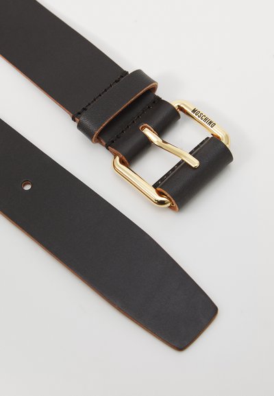 Black leather belt with gold rectangular buckle engraved "Moschino" on a white background.
