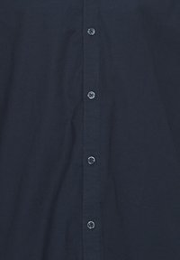 Dark navy blue fabric with a row of six evenly spaced matching buttons centered vertically.