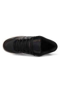 Black sneaker featuring a textured leather upper, smooth toe cap, round laces, and a contrasting rubber outsole. Design includes perforations.