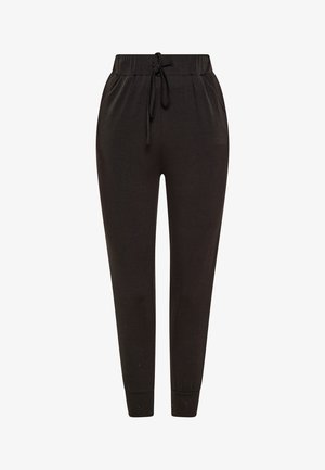 Czarne dresy wykonane z miękkiego materiału. Posiadają elastyczny pas z troczkiem, zwężane nogawki oraz ściągacze przy kostkach.