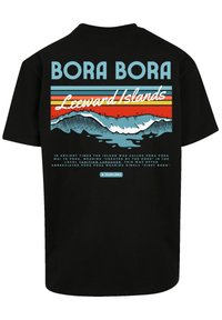 Black t-shirt featuring "BORA BORA" in bold blue text, with wave graphics and colorful horizontal stripes in orange, turquoise, and blue.