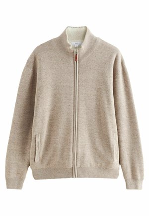 Beige, cipzáros kardigán magas gallérral, bordás mandzsettákkal és szegéllyel. Két oldalsó zseb található rajta, valamint puha belső bélés. Texturált kötött anyagból készült.