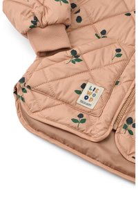 Quilted children's jacket in soft peach fabric with dark rosebud pattern, contrasting ribbed cuffs, and a zipper with a logo label.
