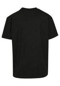 Must must sleeveside koos ümar kaelus, lühikesed varrukad ja mugav lõige. Sile tekstuur, nähtavad mustrid või aktsendid puuduvad. Tagaplane.
