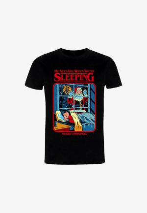 Schwarzes T-Shirt mit kurzen Ärmeln, das ein farbenfrohes Grafikdesign zeigt: Santa am Fenster und ein Kind im Bett, mit dem Text: "Er sieht dich, wenn du schläfst."