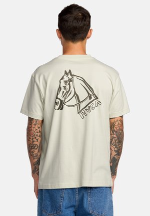 Light beige t-shirt made of cotton, featuring a black horse illustration on the back and the "RVCA" logo below. Short sleeves, relaxed fit.
