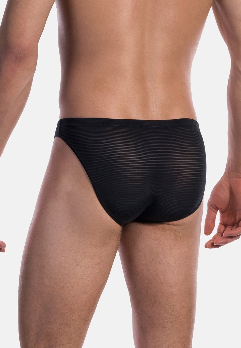 Schwarze Schwimmbrieftaschen mit geripptem Material, im niedrigen Schnitt und minimaler Abdeckung, die ein glattes, elegantes Design präsentieren.