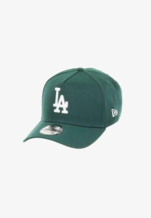 Green baseball cap with white "LA" logo. Features a curved brim and adjustable strap. Made of durable fabric with a smooth texture.