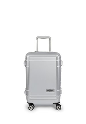Silver hard-shell suitcase with four wheels and a telescopic handle, labeled with the Eastpak brand logo on the front panel.