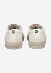 White leather sneakers with a textured beige sole, featuring a soft interior lining and a black "MOMA" logo on the heel tab.