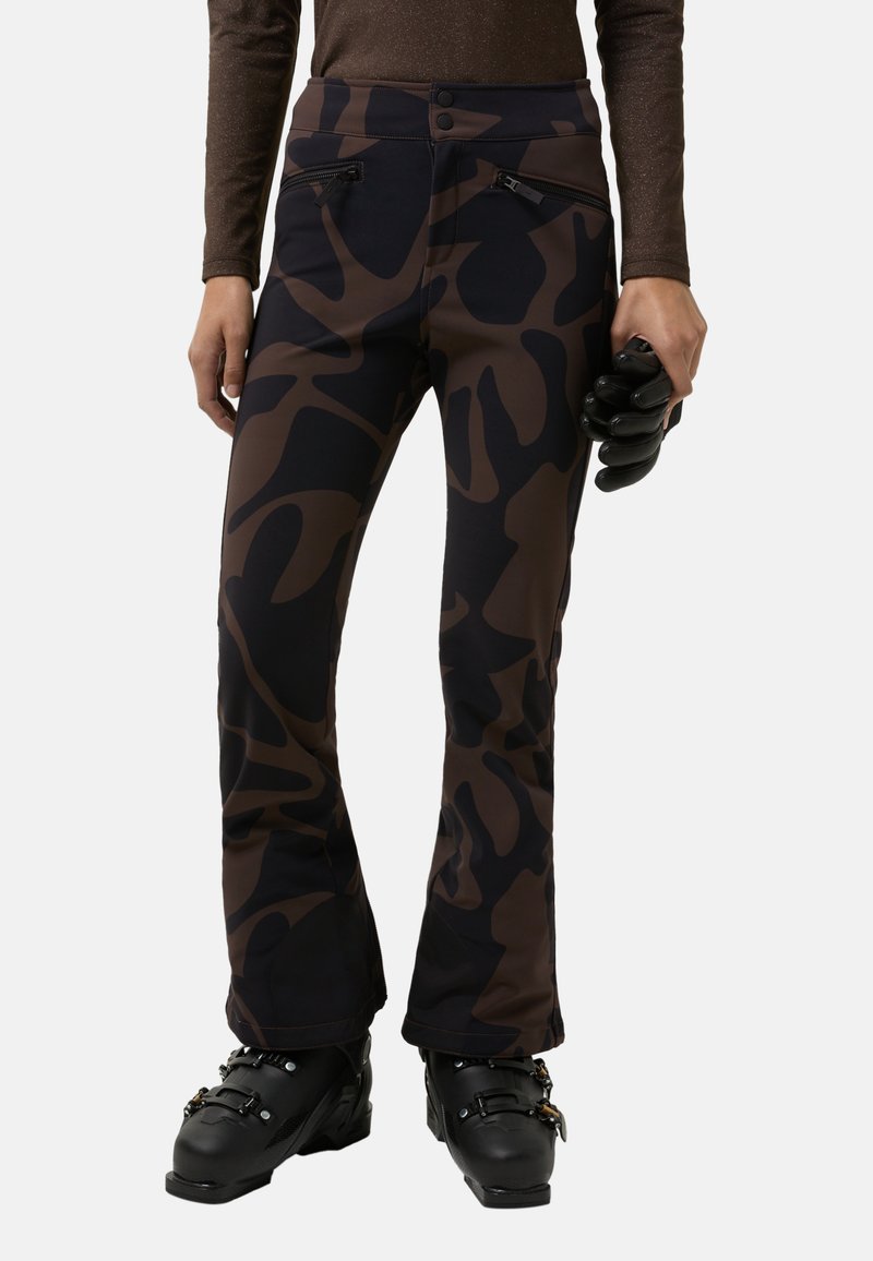 Ski pants in brown and black camouflage pattern, featuring a high waist, two zippered pockets, and slight flare at the ankle.