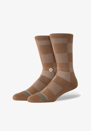 Brown knit socks featuring a checkered pattern in lighter shades, ribbed cuffs, and turquoise accents near the toe.