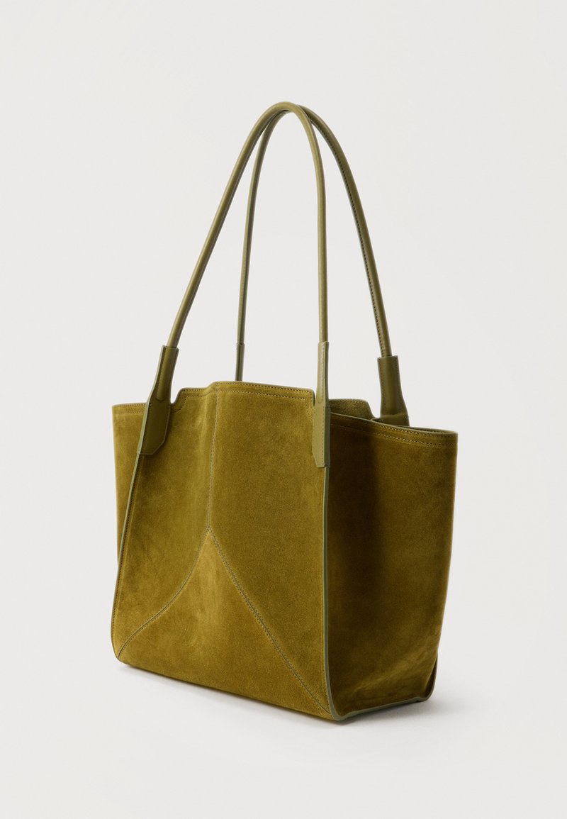 Olive green suede tote bag with two long leather handles and a structured rectangular shape on a white background.