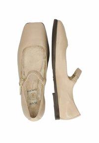 Zapatos de cuero beige con punta cuadrada y una correa lateral, con un interior suave y peludo y un tacón bajo marrón para mayor comodidad.