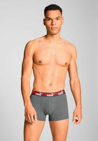 Gray boxer briefs with a contrasting red and navy waistband featuring the Puma logo; medium length, smooth fabric, snug fit.