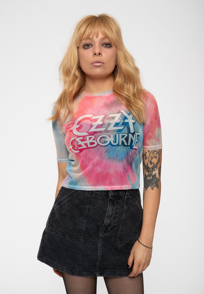 Tie-dye, short-sleeve top in pink and blue with text "OZZY OSBOURNE." Paired with a black denim skirt featuring front pockets and a fitted shape.
