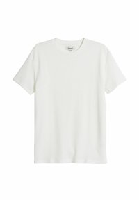 Hvid kortærmet t-shirt i et struktureret stof med rund halsudskæring og lige pasform; har et subtilt vaffelmønster over det hele.