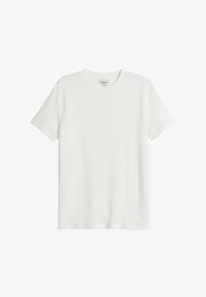 White short-sleeve t-shirt in a textured fabric with a round neckline and straight cut; features a subtle waffle pattern throughout.