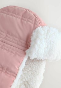 Pink, puffy hat with a soft, white fleece lining and stitched detailing. The outer fabric is smooth and shiny.