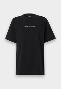 T-shirt preto de mangas curtas com o logótipo "New Balance" em branco centralizado no peito, exibido contra um fundo branco liso.