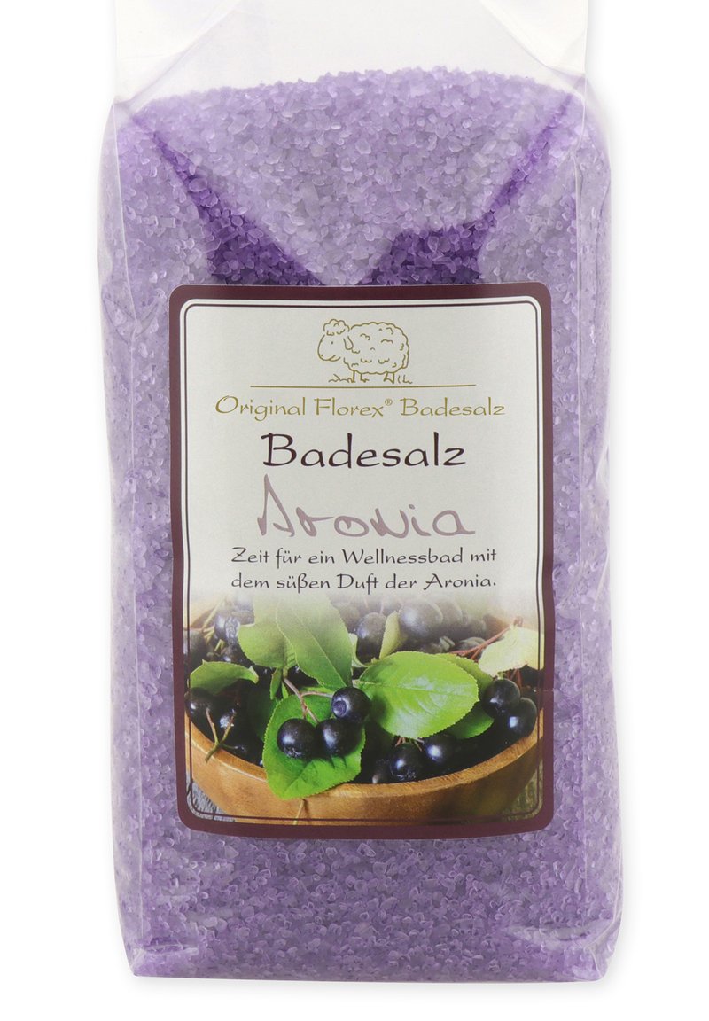 Purple bath salt in a clear bag, featuring a label with green leaves and dark berries, and a cartoon sheep logo. Suitable for relaxation.
