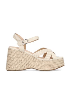 Sandalias de cuña de color crema con plataforma de yute trenzado y diseño de tiras cruzadas. Cuenta con una correa en el tobillo con hebilla para un ajuste seguro.