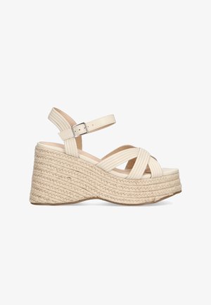 Sandalias de cuña de color crema con plataforma de yute trenzado y diseño de tiras cruzadas. Cuenta con una correa en el tobillo con hebilla para un ajuste seguro.