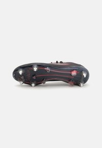 Black soccer cleat with a textured upper, featuring red accents and a durable rubber sole. Five metal studs for traction.