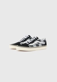 Black and gray checkered canvas sneakers with white laces, rounded toe, and contrasting black suede accents on the toe cap and sides.