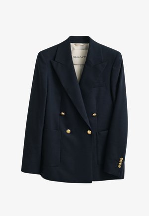 Blazer doppiopetto blu navy con bottoni dorati, rever con intaglio, due tasche frontali e una piccola tasca sul petto.