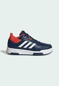 Marineblauwe sportschoenen met een gestructureerde leren bovenzijde, rode mesh accenten, witte drie-strepen branding en een witte rubberen zool.