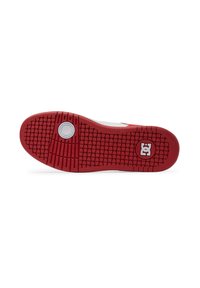 Suela de zapato de goma roja con patrón texturizado, logo blanco circular en el centro y surcos elevados para tracción. Diseño limpio y atlético.