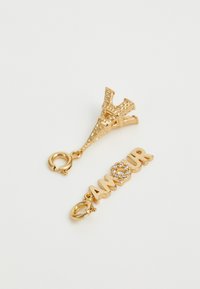 Gold charm featuring an Eiffel Tower design and the word "AMOUR" with a rhinestone accent, both on lobster clasps.