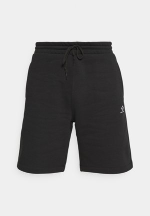 Schwarze Shorts aus Baumwollmischung mit elastischem Bund, Kordelzugverschluss und einem weißen Logo-Akzent auf der Vorderseite. Glatte Textur.