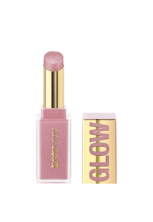 Stick illuminante rosa shimmer con base quadrata dorata e trasparente accanto al tappo dorato con la scritta "GLOW" in lettere glitter rosa.