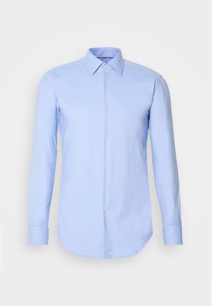 Camicia a maniche lunghe di color azzurro chiaro in cotone, con bottoni sul fronte, colletto e orlo arrotondato. Tessuto liscio senza motivi.